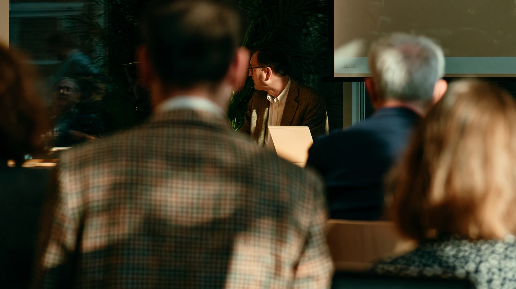 A practitioner presenting to a room of colleagues
